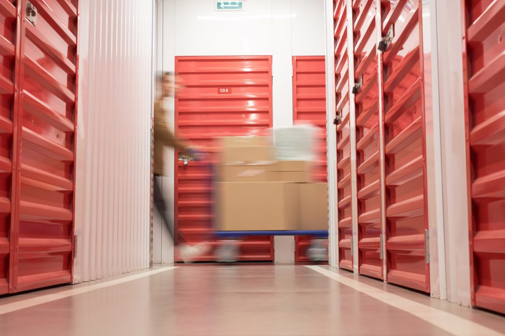 Storage Customer Pushing Cart in Warehouse